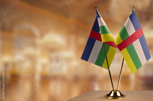 Small flags of the Central African Republic on an abstract blurry background
