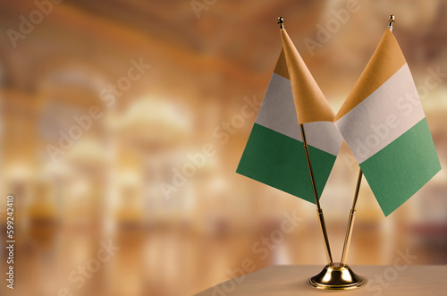 Small flags of the Cote dIvoire on an abstract blurry background photo