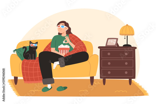A young woman and her cat are sitting on a cozy sofa and watching a movie