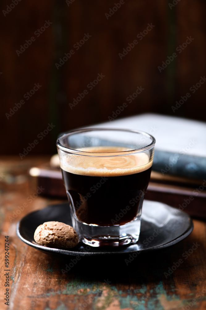 Coffee in glass cup on dark wooden background. Copy space. Coffee in glass cup on dark wooden background. Copy space.