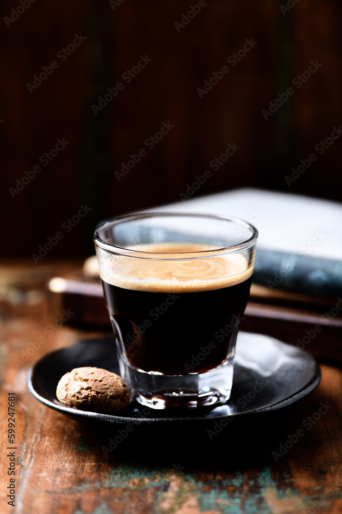 Coffee in glass cup on dark wooden background. Copy space. Coffee in glass cup on dark wooden background. Copy space.