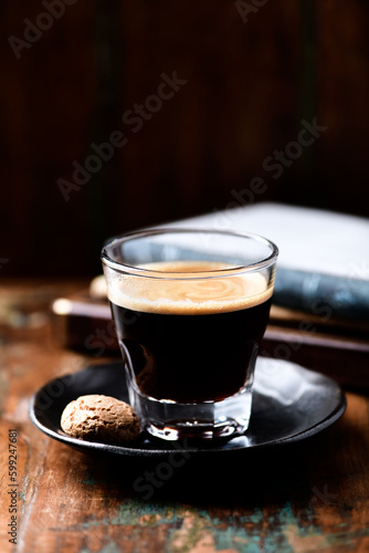 Coffee in glass cup on dark wooden background. Copy space. 