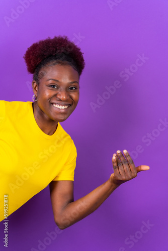 Photography Young african american woman isolated on a purple background inviting to come wi