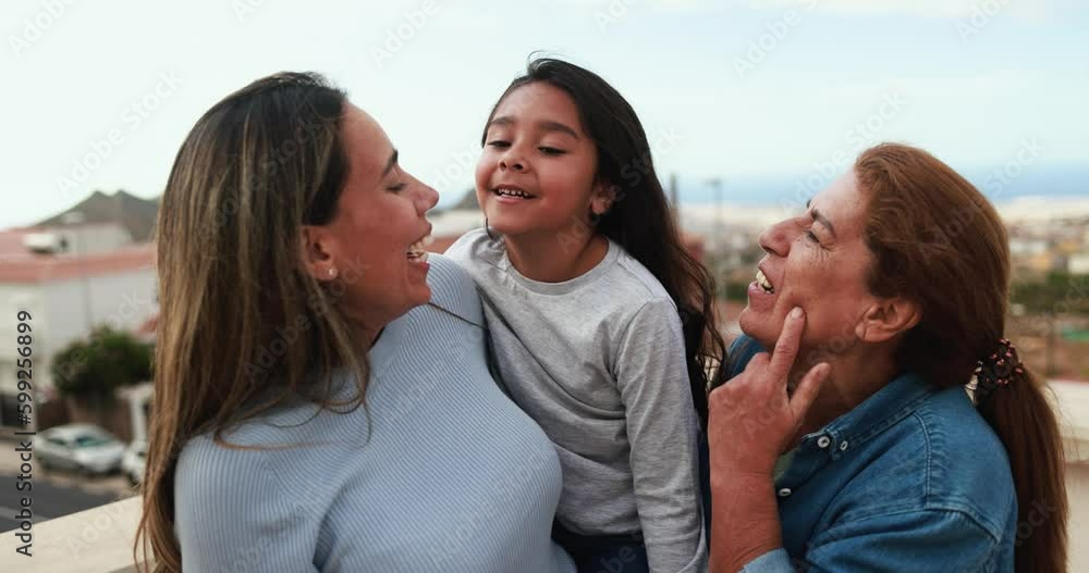 Happy latin multi generational family having fun together while smiling in front of camera at house rooftop Happy latin multi generational family having fun together while smiling in front of camera at house rooftop