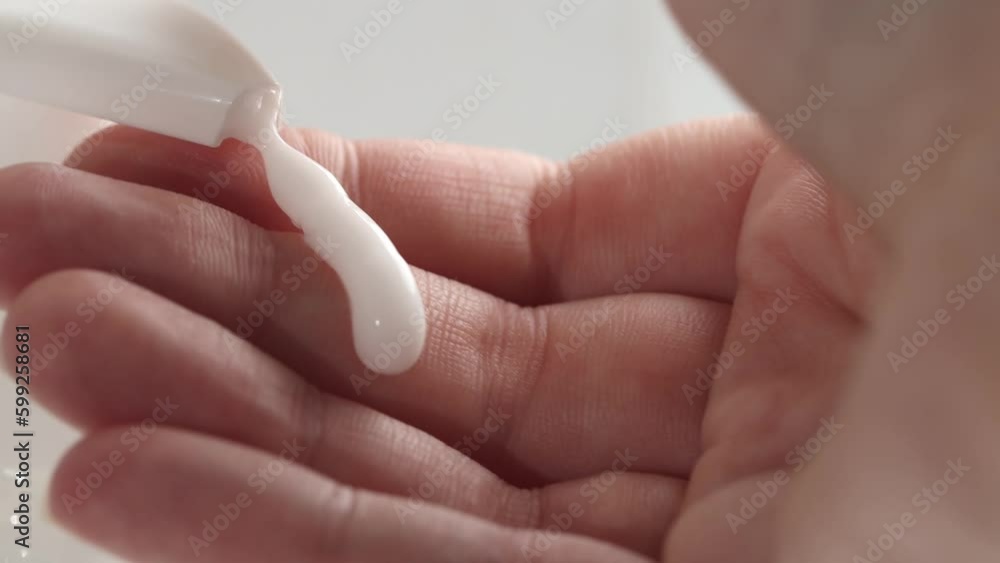 A woman's hand applies a cream to the skin from a container. Body care, moisturizing and anti-aging, macro. A woman's hand applies a cream to the skin from a container. Body care, moisturizing and anti-aging, macro.