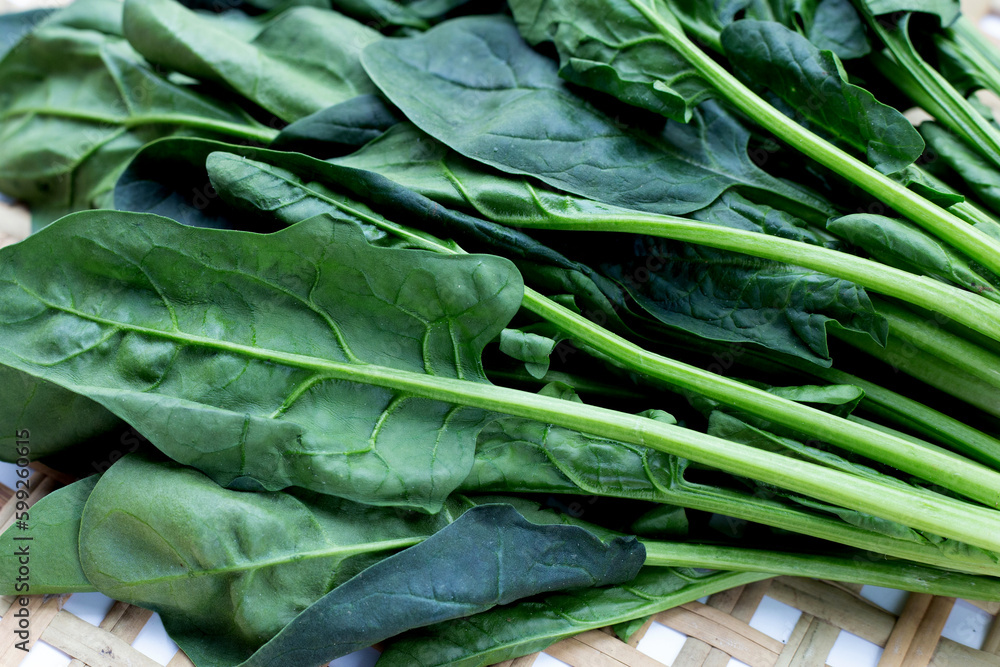 Fresh spinach in bamboo weaves plate Fresh spinach in bamboo weaves plate