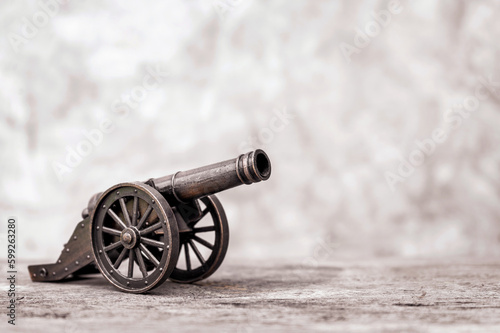 Photos Ancient cannon on steel wheels with wall background retro style and copy space
