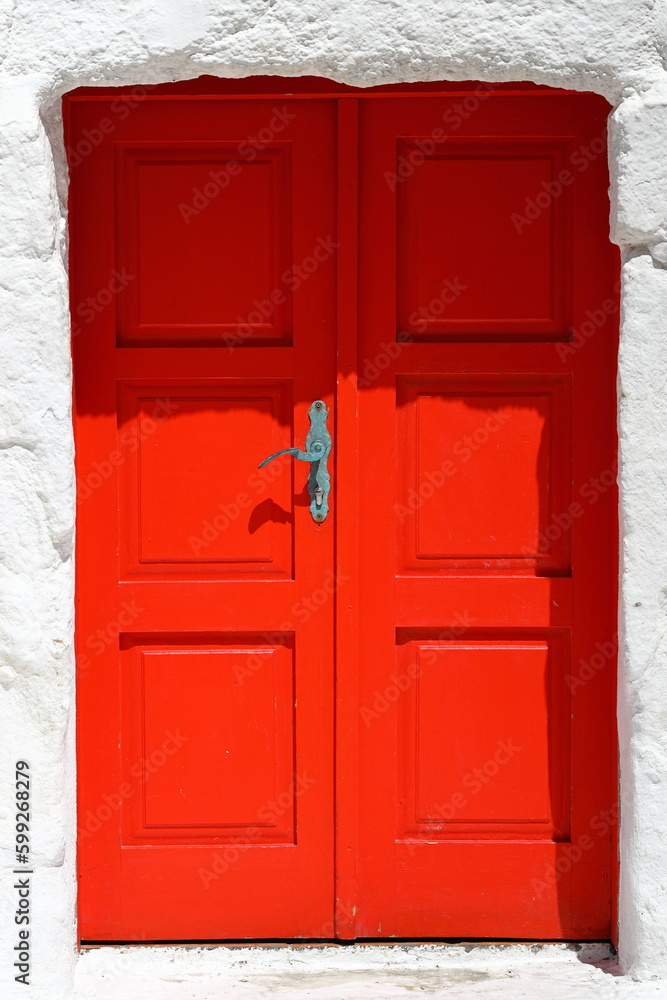 old red door next to white wall