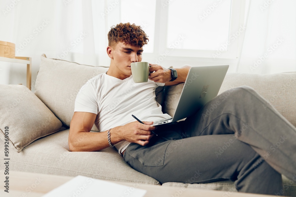Fototapeta premium man interior lifestyle call notebook job laptop phone room cup education computer technology