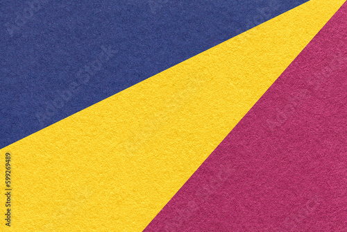 Texture of old craft navy blue, yellow and purple color paper background, macro. Vintage abstract cardboard