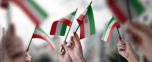 Fototapeta Naklejka Na Ścianę i Meble -  A group of people holding small flags of the Iran in their hands
