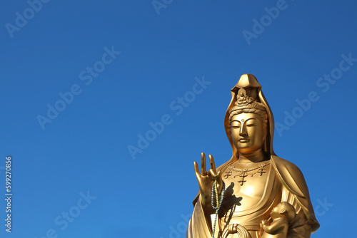 Jibo Kannon Golden Statue nearby Fushimi Inari  Buddhist Goddess of Mercy  Buddha isolated sculpture