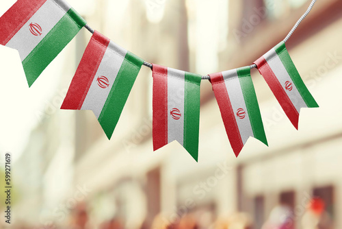 A garland of Iran national flags on an abstract blurred background