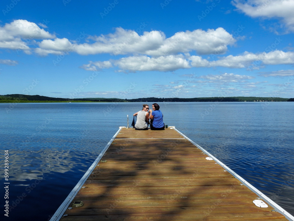 Best friends hanging out on the dock at the cottage Best friends hanging out on the dock at the cottage
