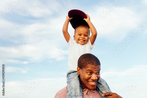 Father giving daughter (2-3) piggyback ride