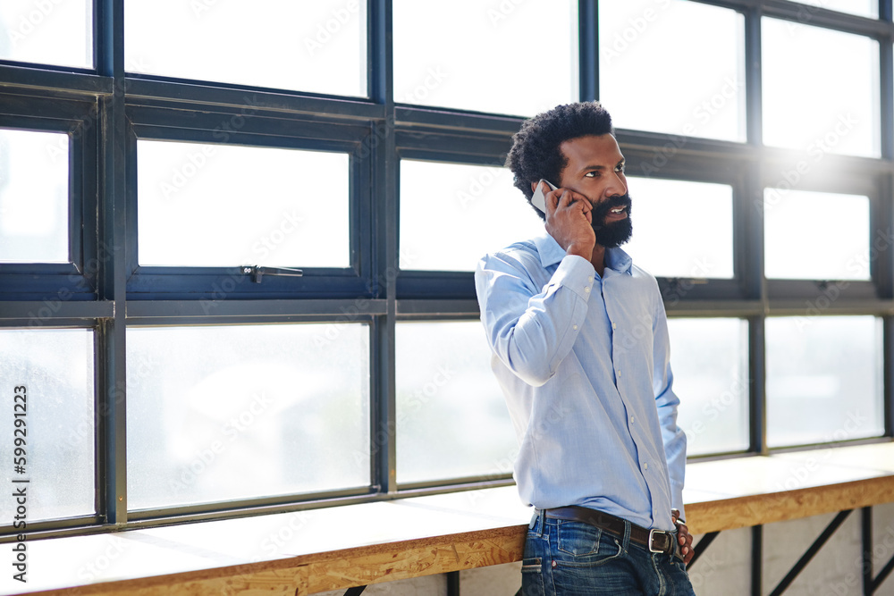Explain it to me...a businessman talking on his cellphone in an office. Explain it to me...a businessman talking on his cellphone in an office.
