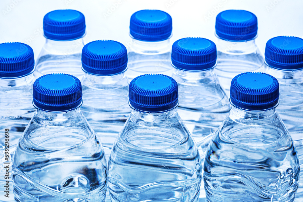 pile of half litre plastic water bottles with blue cap pile of half litre plastic water bottles with blue cap