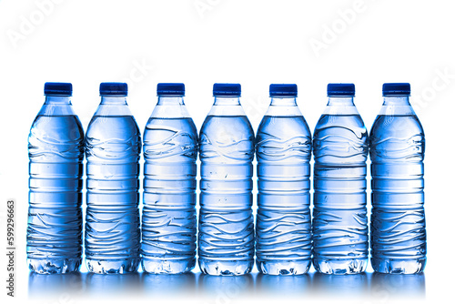 pile of half litre plastic water bottles with blue cap