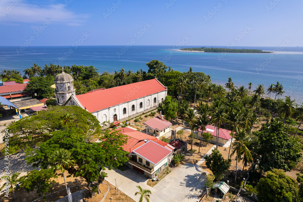 Aerial Anini-y Church or the Parish Church of San Juan Nepomuceno, and the nearby Nogas Island.