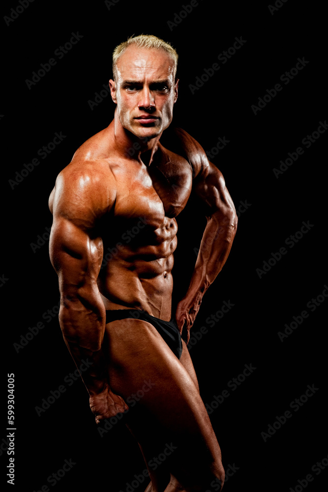 Bodybuilder on black background in the studio Bodybuilder on black background in the studio