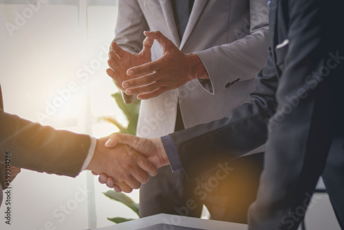 Businessman clapping two businessmen shaking hands When a successful project