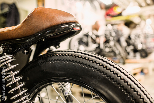 Close up of retro motorcycle wheel and leather seat