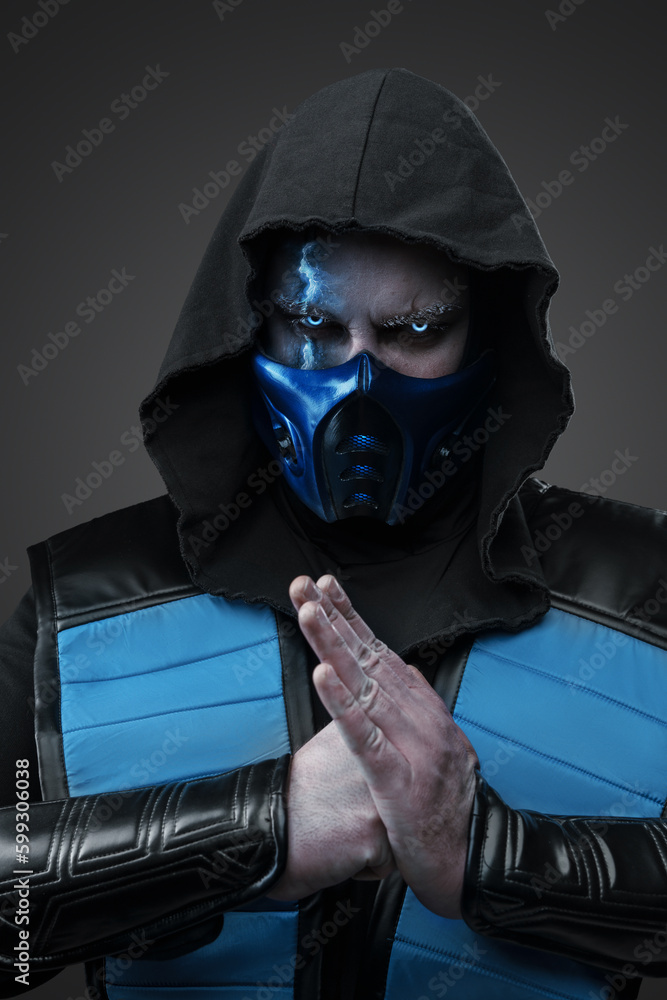 Shot of Ice assassin dressed in hood with fist and palm looking at camera. Shot of Ice assassin dressed in hood with fist and palm looking at camera.
