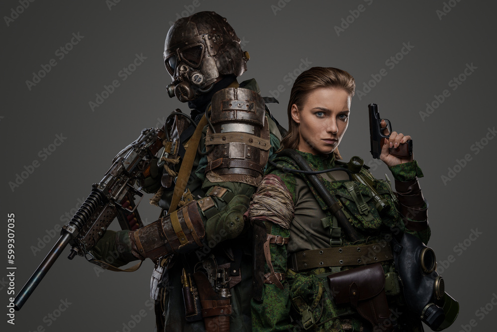 Shot of two military people together with pistol and shotgun against grey background. Shot of two military people together with pistol and shotgun against grey background.