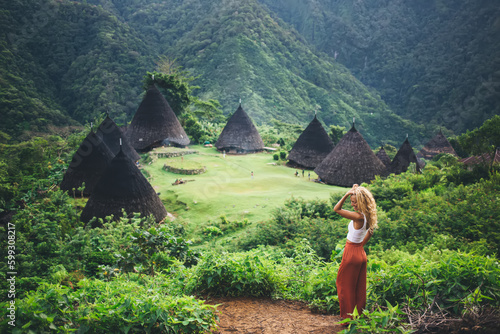 Carefree woman traveler near Wae Rebo village photo