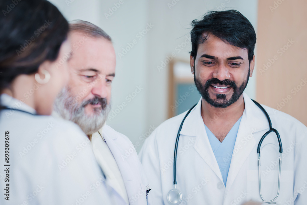 Professional Medical Doctors and team discussing in clinic hall, healthcare professionals having discussion in hospital corridor. Professional Medical Doctors and team discussing in clinic hall, healthcare professionals having discussion in hospital corridor.