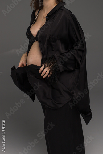 woman in a black dress posing in studio
