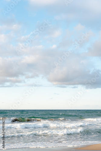 Background image of turquoise sea and sandy coast on a sunny day.