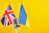 Microphone on a background of a blurry flags Ukraine and Great Britain. European Song Contest Liverpool.