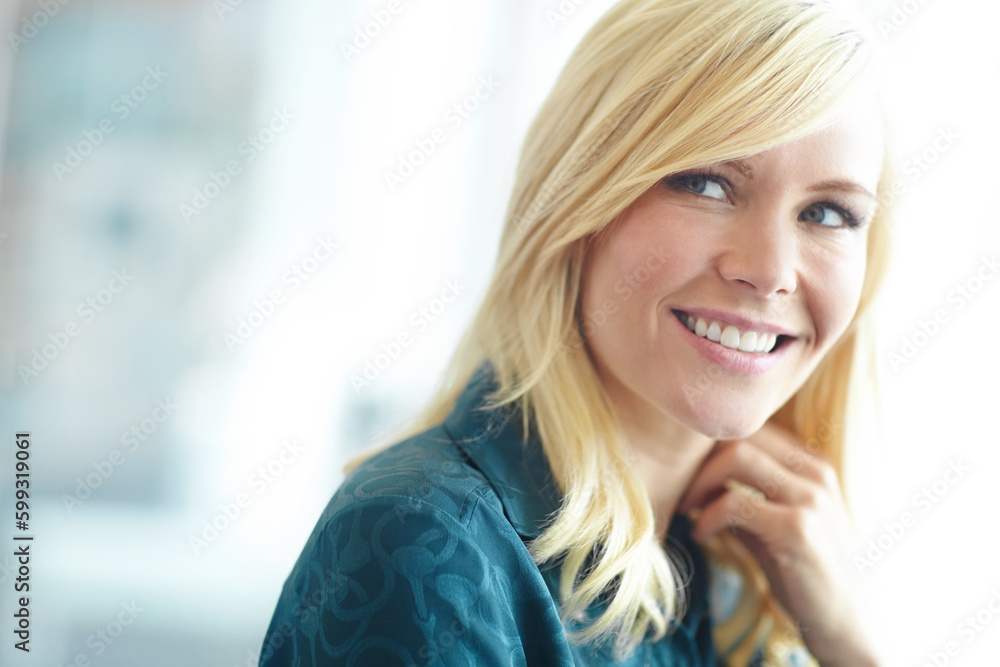 Shes got confidence. a beautiful smiling blonde woman looking to the side with copyspace.