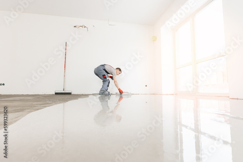 Screed concrete with self leveling cement mortar for floors. Master work renovation home with sunlight © Parilov
