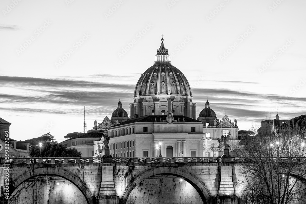 Black and white view of St. Peter's Basilica in the Vatican, the Pope's church, from Via della Conciliazione at night with lights. Vatican Rome Italy Europe. The most beautiful place in world