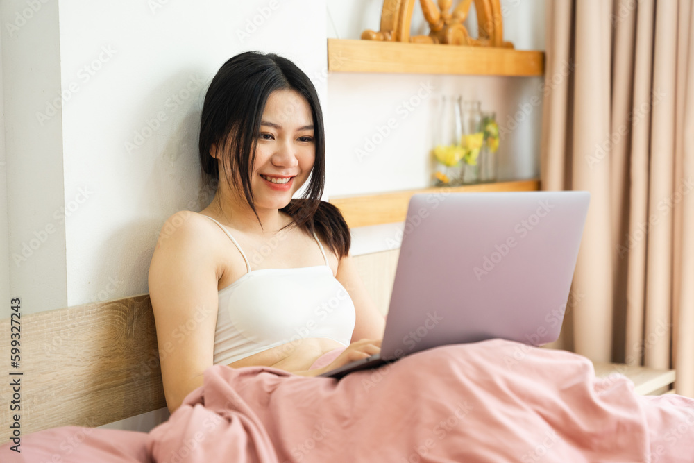 Portrait of a beautiful and playful asian girl in bed in the morning Portrait of a beautiful and playful asian girl in bed in the morning