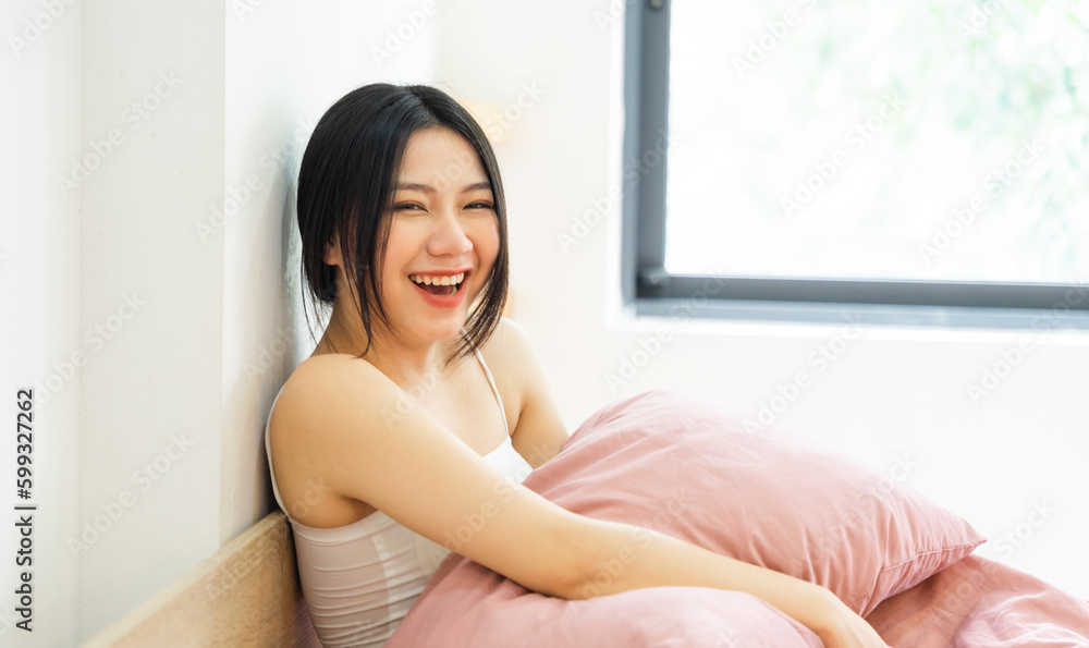 Portrait of a beautiful and playful asian girl in bed in the morning Portrait of a beautiful and playful asian girl in bed in the morning