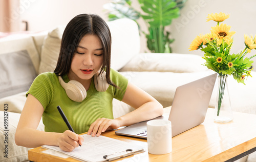 Portrait of a happy asian woman relaxing at home