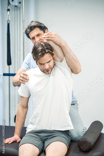 Physical therapist working with patients neck