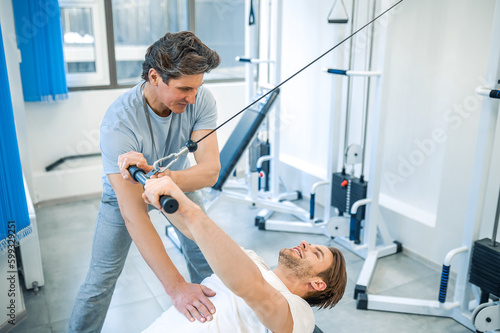 Physical therpaist working with the patient in a rehabilitation center photo