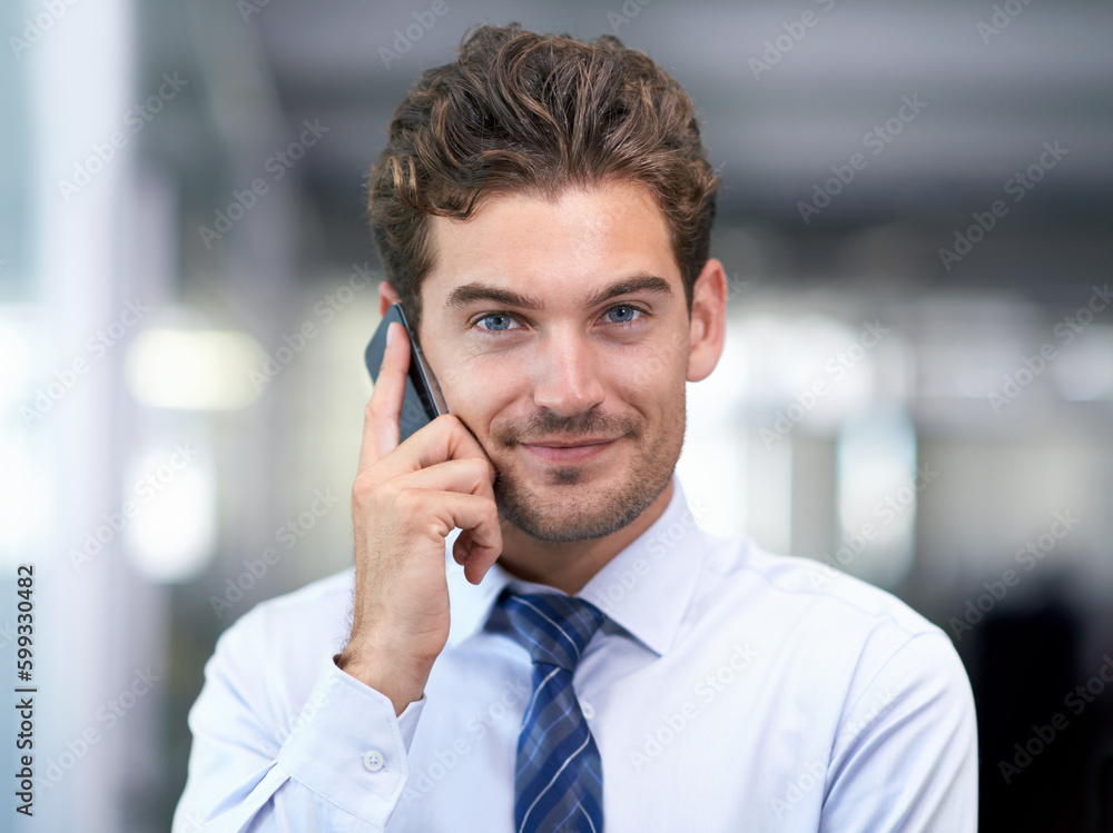 Always available to my clients. a handsome young businessman talking on his cellphone at work. Always available to my clients. a handsome young businessman talking on his cellphone at work.