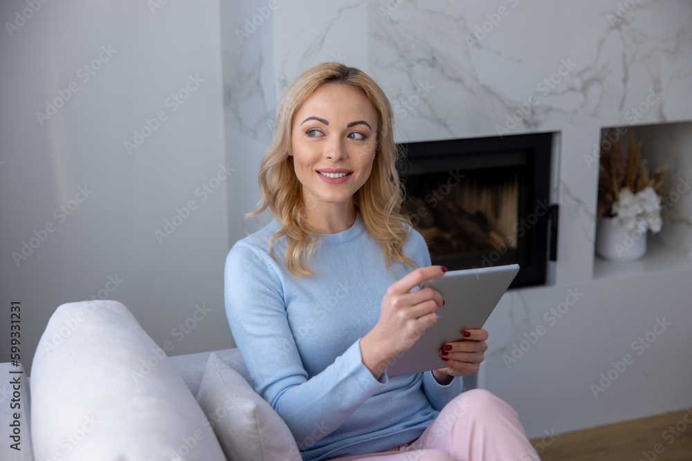 Cheerful female daydreaming with a digital tablet in the hands Cheerful female daydreaming with a digital tablet in the hands