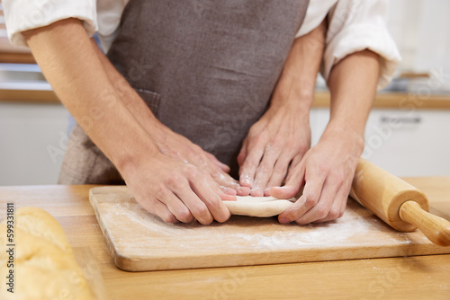 close up gay couple hands making a bread together in the kitchen
