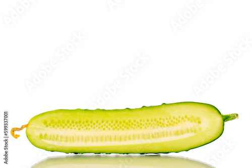 One half of a ripe gherkin cucumber, macro, isolated on white background.