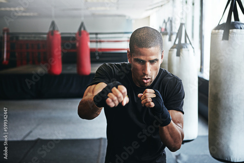 Today is another opportunity to tap into your greatness. a kick-boxer training in a gym.