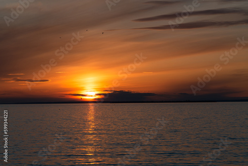 sunset over the sea. the sun sets in the water © Наталия Бушкевич