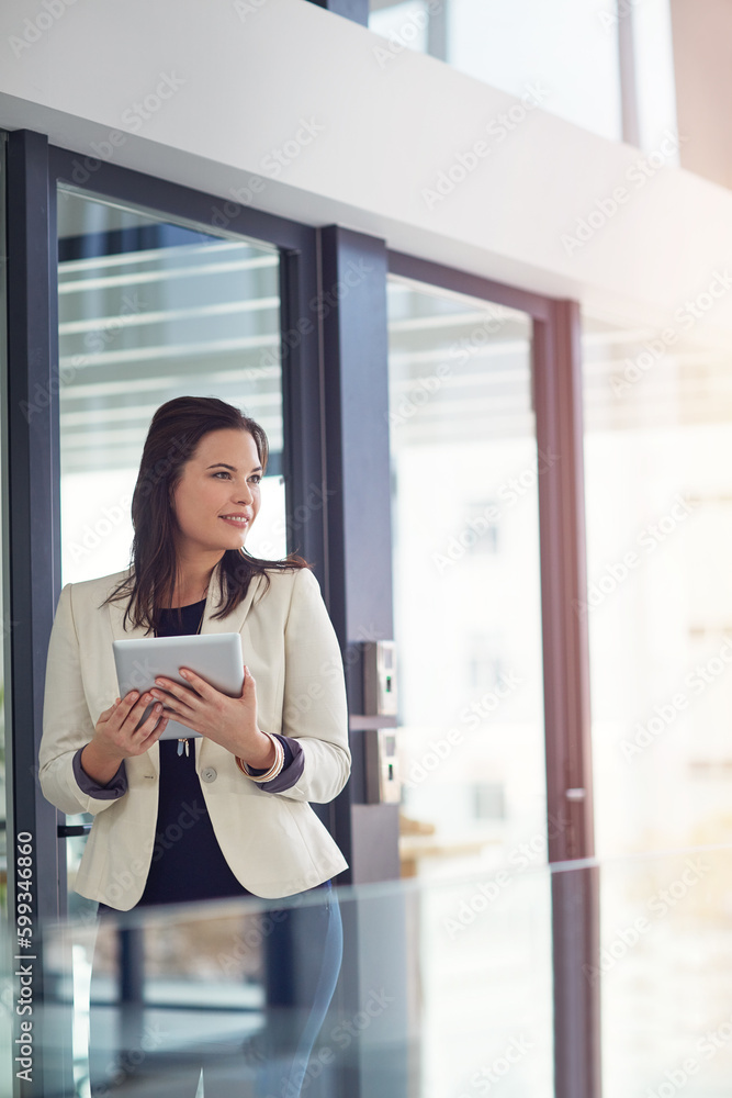 Bringing a positive attitude forward. a young businesswomen using a digital tablet in an office. Bringing a positive attitude forward. a young businesswomen using a digital tablet in an office.