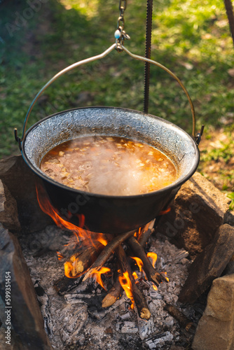 Delicious meal (goulash) made on traditional way in fish pot on camp fire