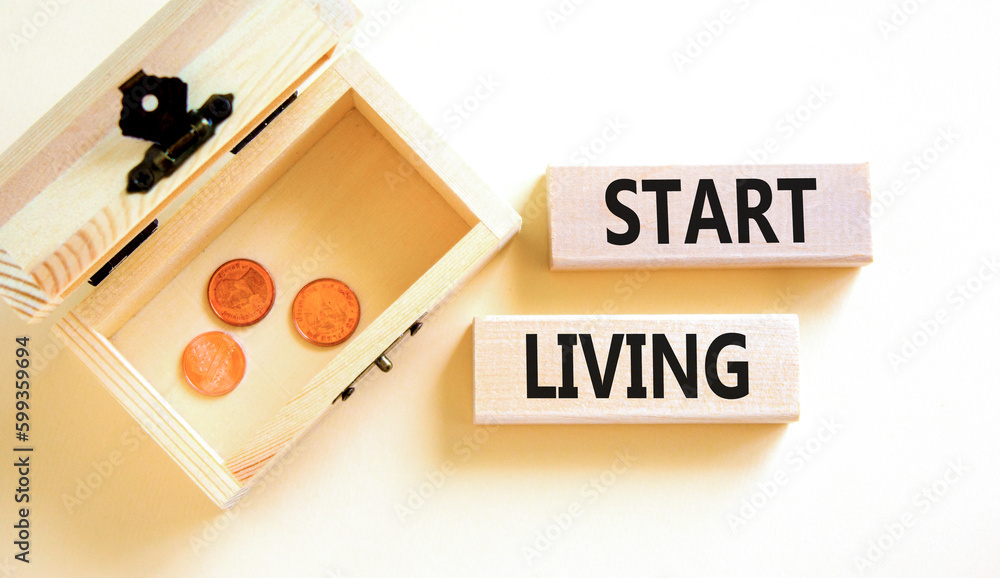 Start living symbol. Concept words Start living on beautiful wooden block. Beautiful white table white background. Wooden chest with coins. Business and Start living concept. Copy space. Start living symbol. Concept words Start living on beautiful wooden block. Beautiful white table white background. Wooden chest with coins. Business and Start living concept. Copy space.